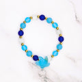 Handmade beach glass stretch bracelet with starfish charm and gold accents