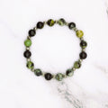 Handmade China chrysoprase stretch bracelet with silver accent beads, flat lay