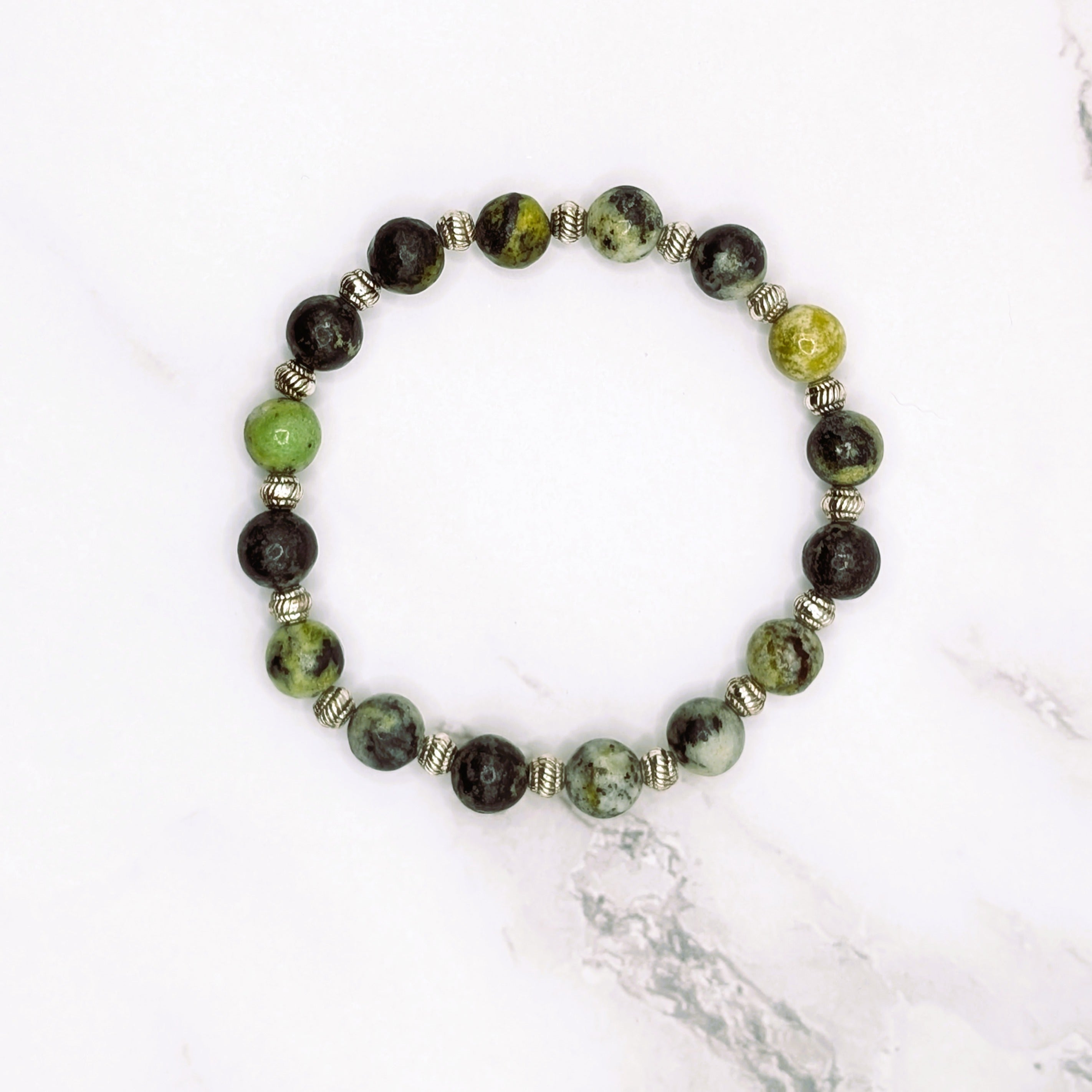 Handmade China chrysoprase stretch bracelet with silver accent beads, flat lay