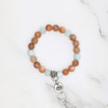 Handmade peach moonstone and green angelite stretch bracelet with lotus charm