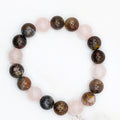 Handmade rose quartz and pietersite stretch bracelet, flat lay on marble