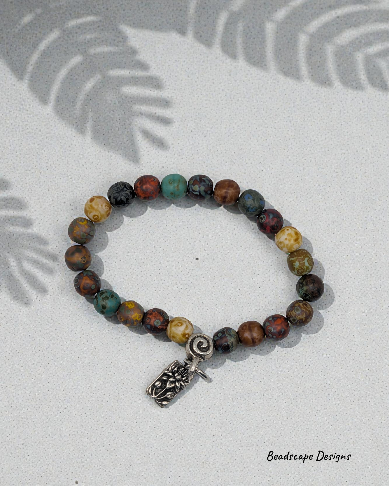 Stretch Bracelet with Czech Glass Picasso Beads and a Lotus Charm